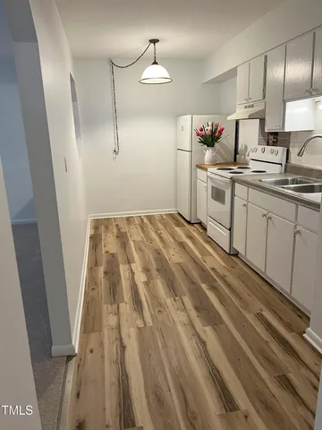 a kitchen with a sink and refrigerator