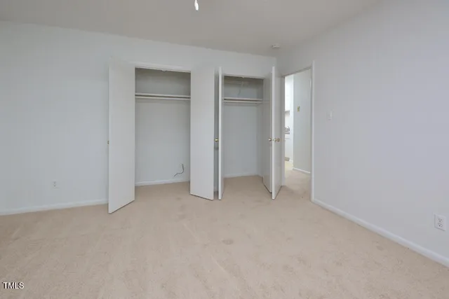 a view of an empty room and closet area