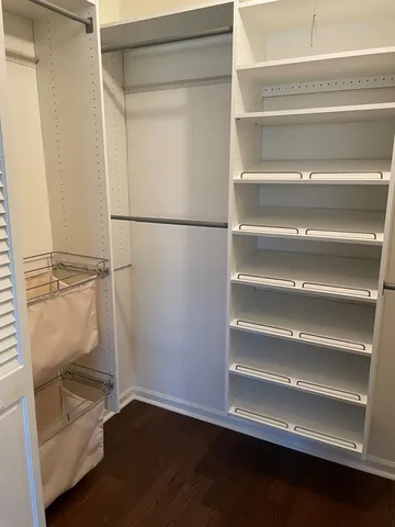 a view of walk in closet with empty racks