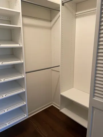 a spacious bathroom with a granite countertop double vanity sink and mirror