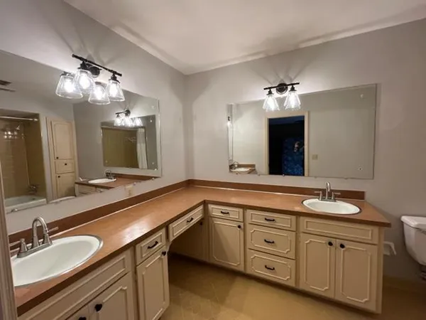 a spacious bathroom with a granite countertop sink mirror and shower