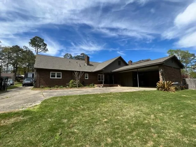a view of a yard with plants and trees