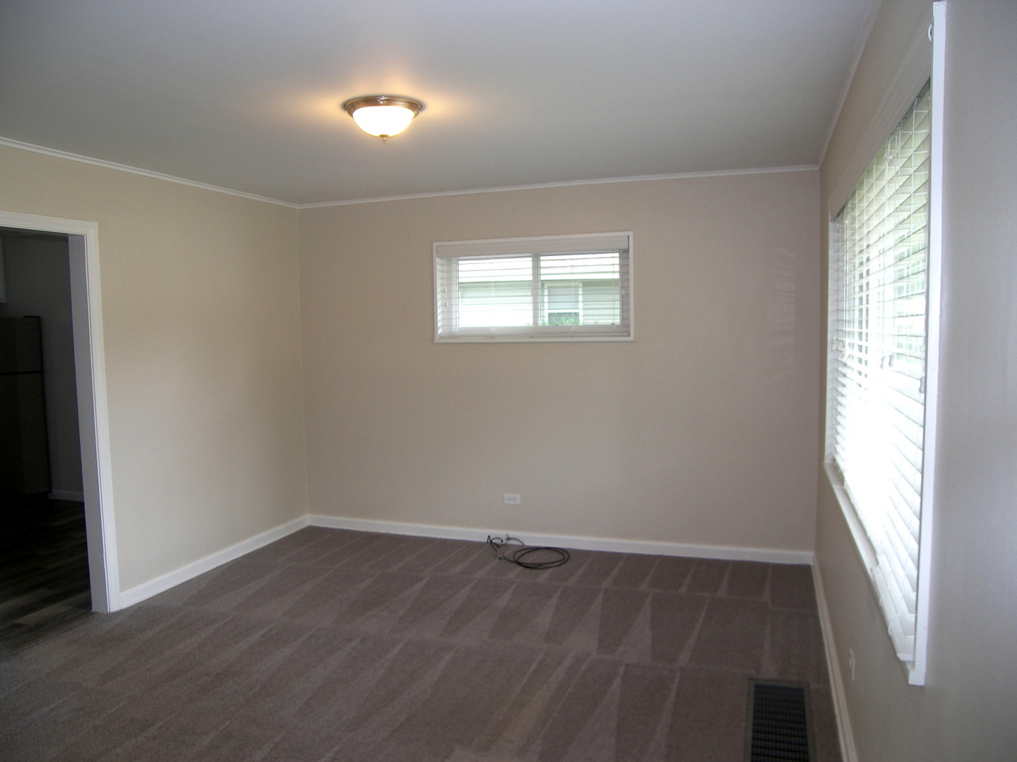 8 Crescent Road Lake Zurich, IL 60047 - Photo 4 of 17 an empty room with wooden floor and windows