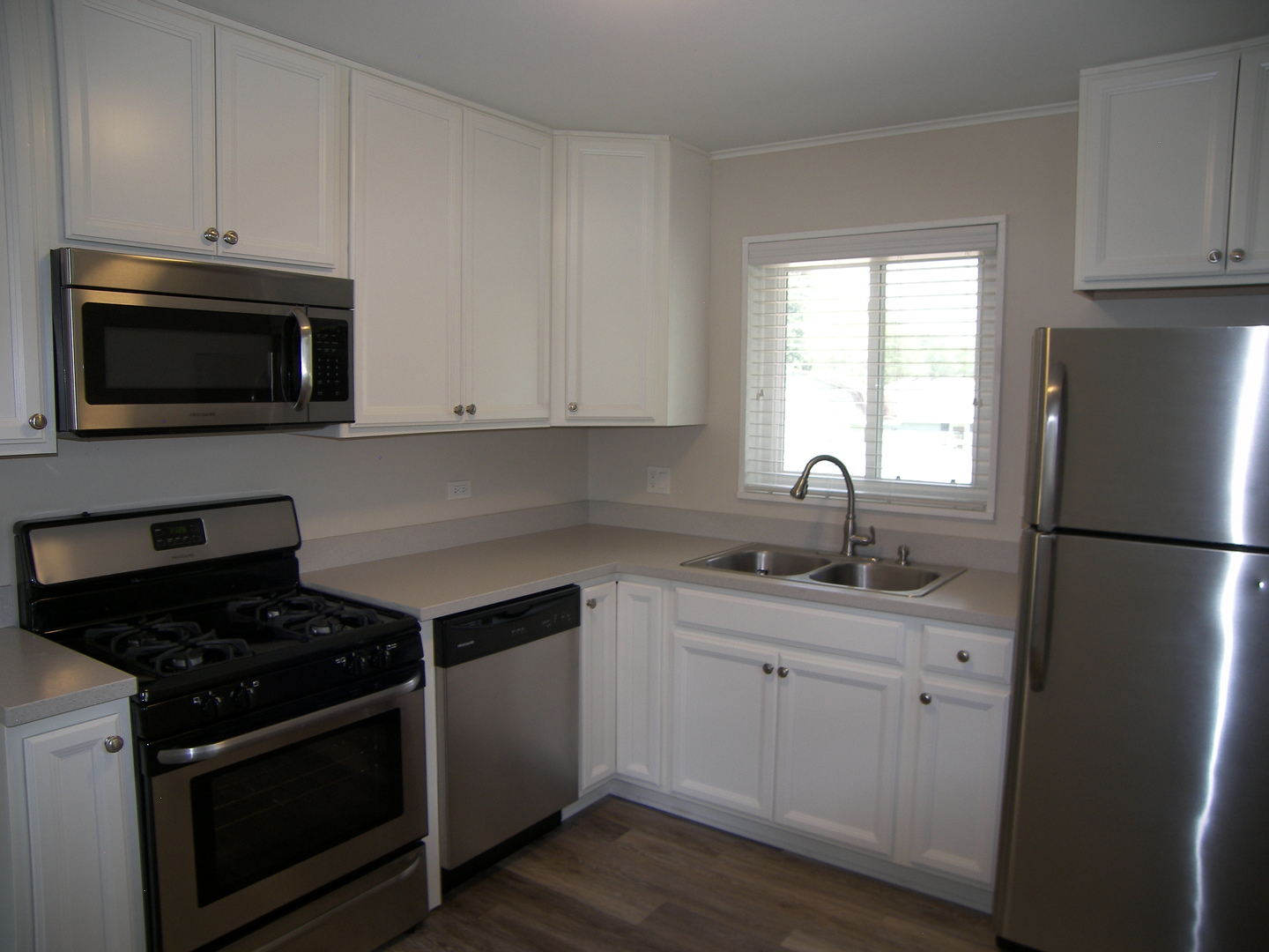 8 Crescent Road Lake Zurich, IL 60047 - Photo 6 of 17 a kitchen with granite countertop white cabinets and stainless steel appliances