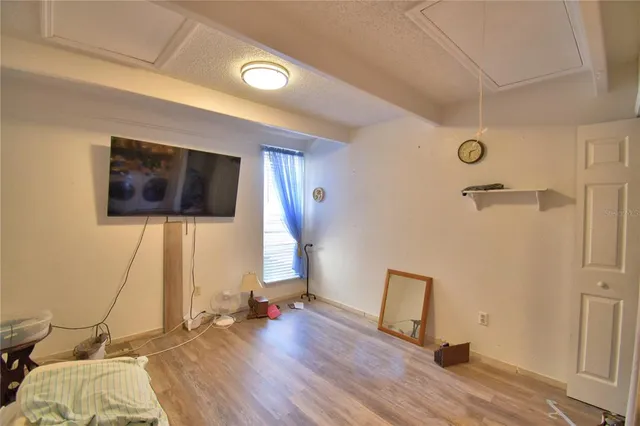 a view of a livingroom with wooden floor and a ceiling fan