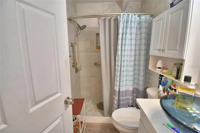 a bathroom with a sink toilet and shower