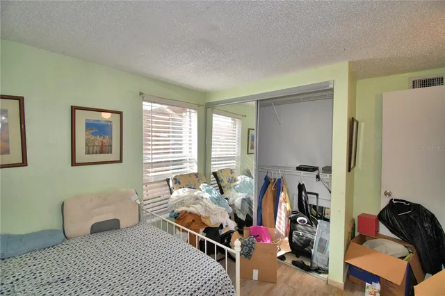 a bedroom with furniture and a window