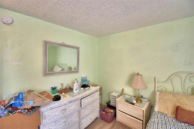 a bedroom with furniture and a wooden floor