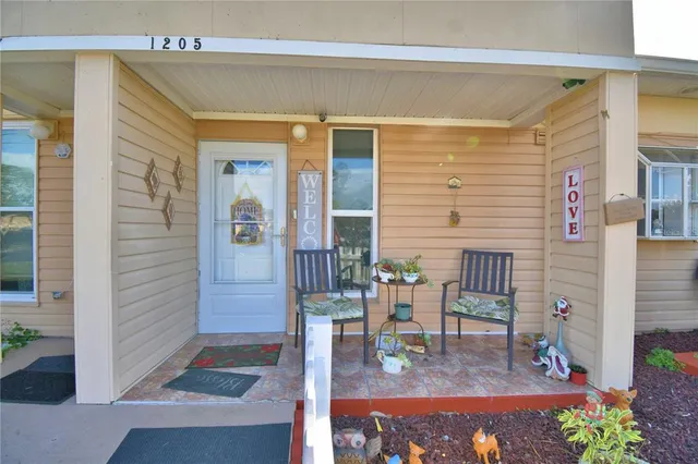 a view of living room with a table and chairs