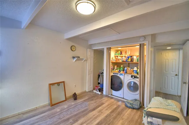 a view of a bedroom with a bed and a window