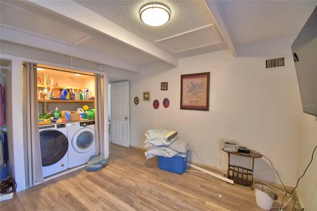 a view of a bedroom with washer and dryer