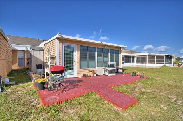 a view of a house with backyard porch and sitting area