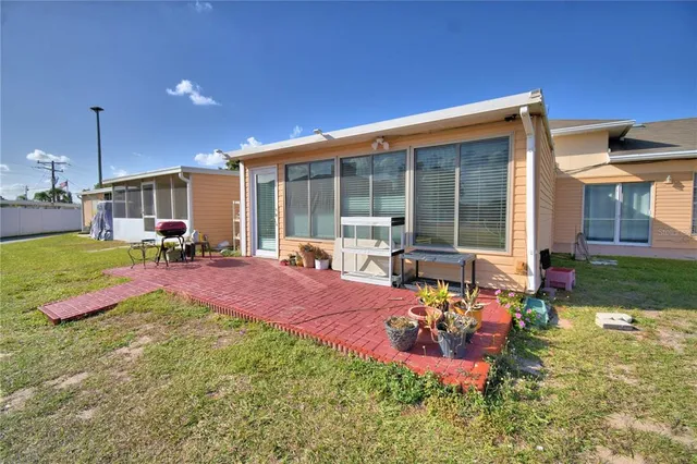 a view of a house with backyard outdoor seating area and furniture