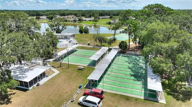 an aerial view of a house with a yard basket ball court and outdoor seating