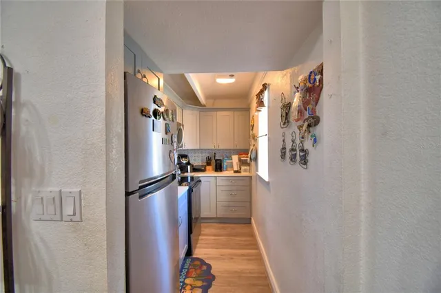 a kitchen with refrigerator and car