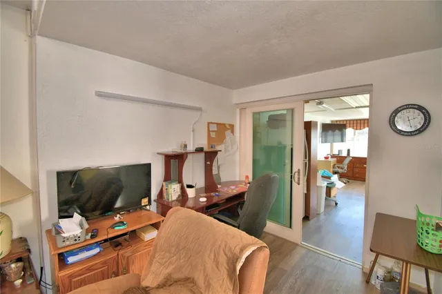 a bedroom with furniture and a flat screen tv