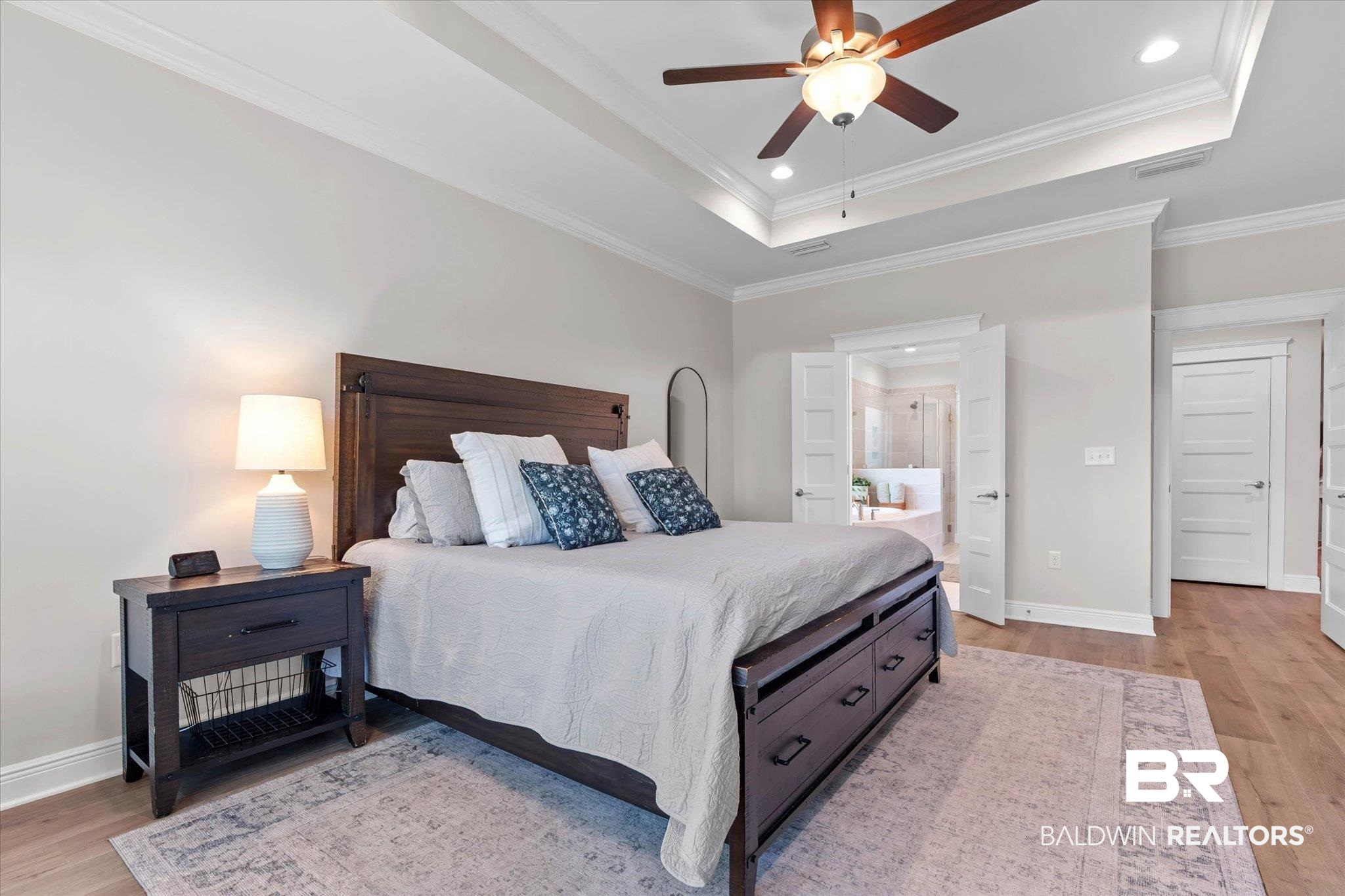 23523 Travis Stock Street Foley, AL 36535 - Photo 15 of 45 Spacious bedroom featuring wood-finish flooring, a tray ceiling with crown molding and a ceiling fan, and recessed lighting
