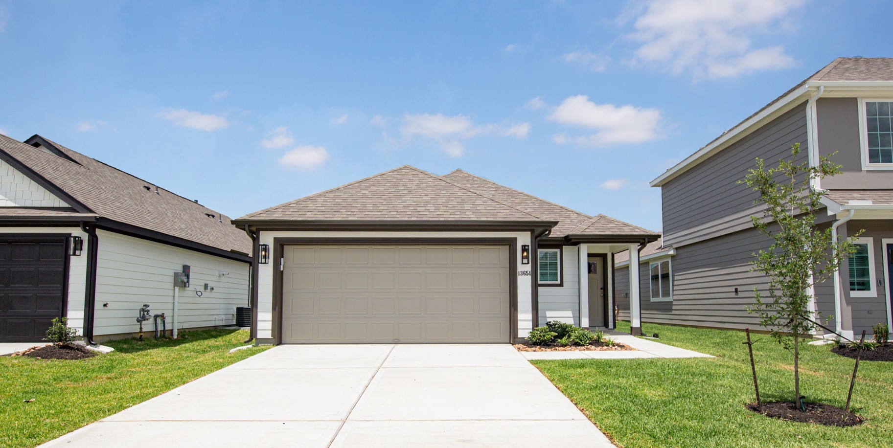 13654 Kit Run Splendora, TX 77372 - Photo 2 of 24 a front view of a house with a yard and garage