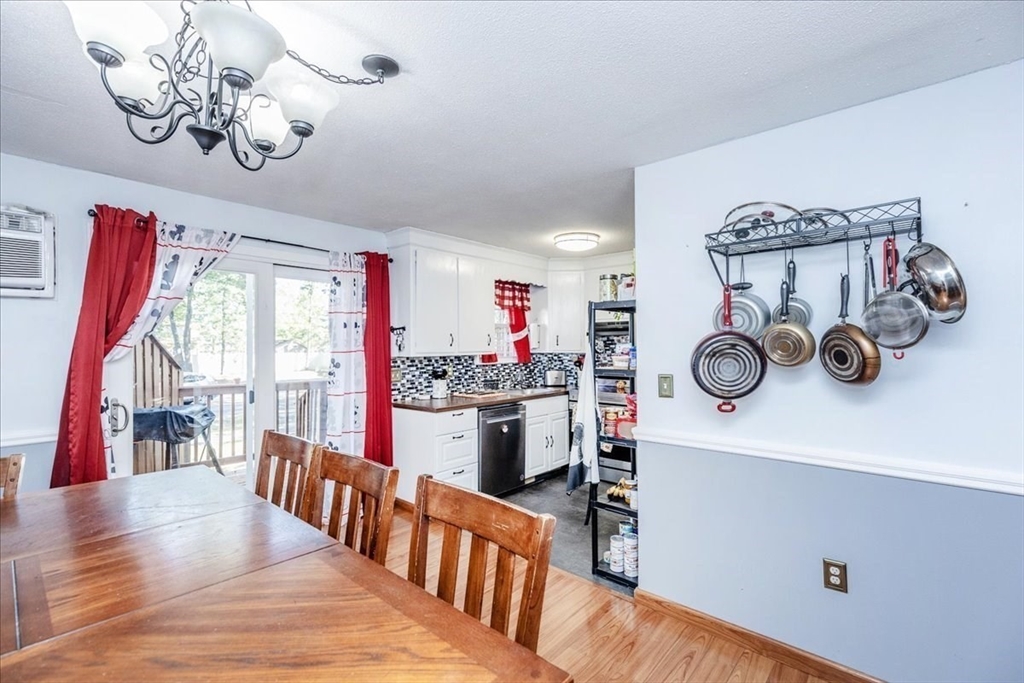 75 Sandy Pond Road, Unit 7 Ayer, MA 01432 - Photo 11 of 37 a kitchen with kitchen island a wooden floor and window