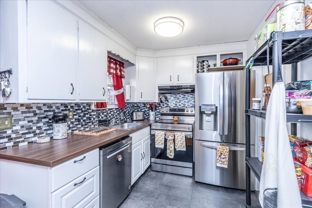 75 Sandy Pond Road, Unit 7 Ayer, MA 01432 - Photo 13 of 37 a kitchen with stainless steel appliances granite countertop a refrigerator and a sink