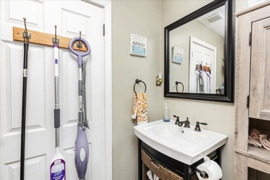 75 Sandy Pond Road, Unit 7 Ayer, MA 01432 - Photo 17 of 37 a bathroom with a sink and a mirror
