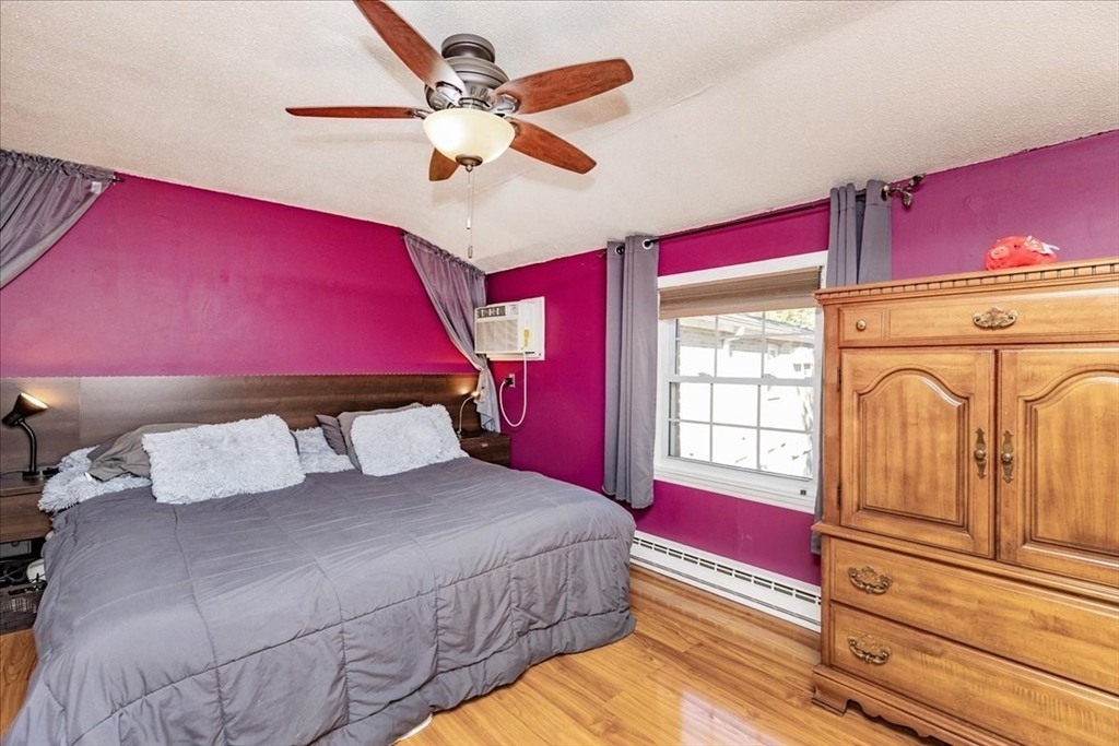 75 Sandy Pond Road, Unit 7 Ayer, MA 01432 - Photo 18 of 37 a bedroom with a bed a closet and flat screen tv