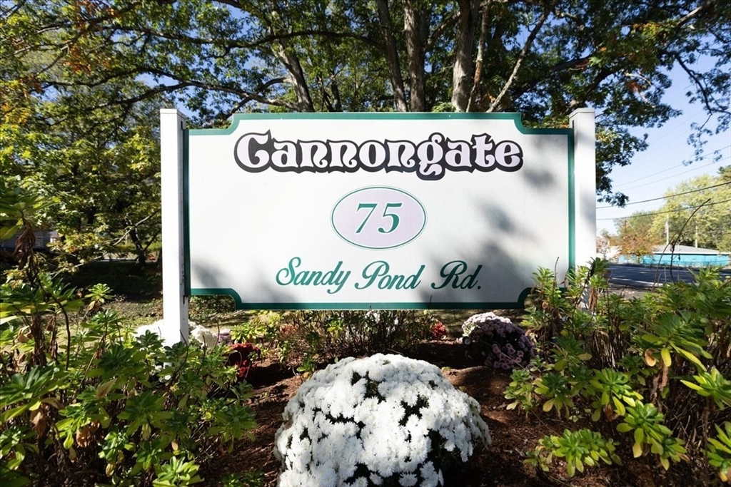 75 Sandy Pond Road, Unit 7 Ayer, MA 01432 - Photo 2 of 37 a sign that is on a wooden wall