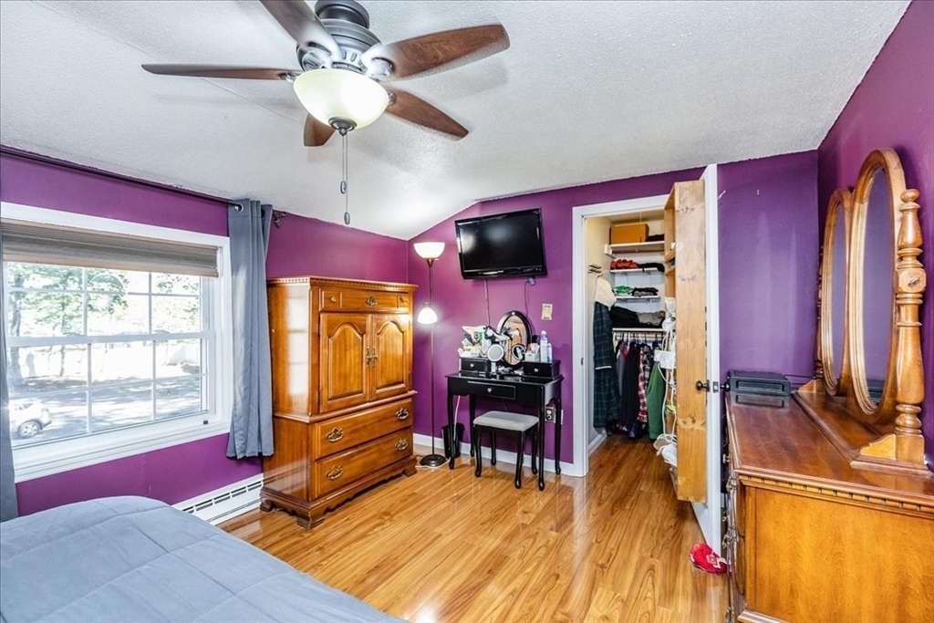 75 Sandy Pond Road, Unit 7 Ayer, MA 01432 - Photo 21 of 37 a living room with furniture piano and a flat screen tv