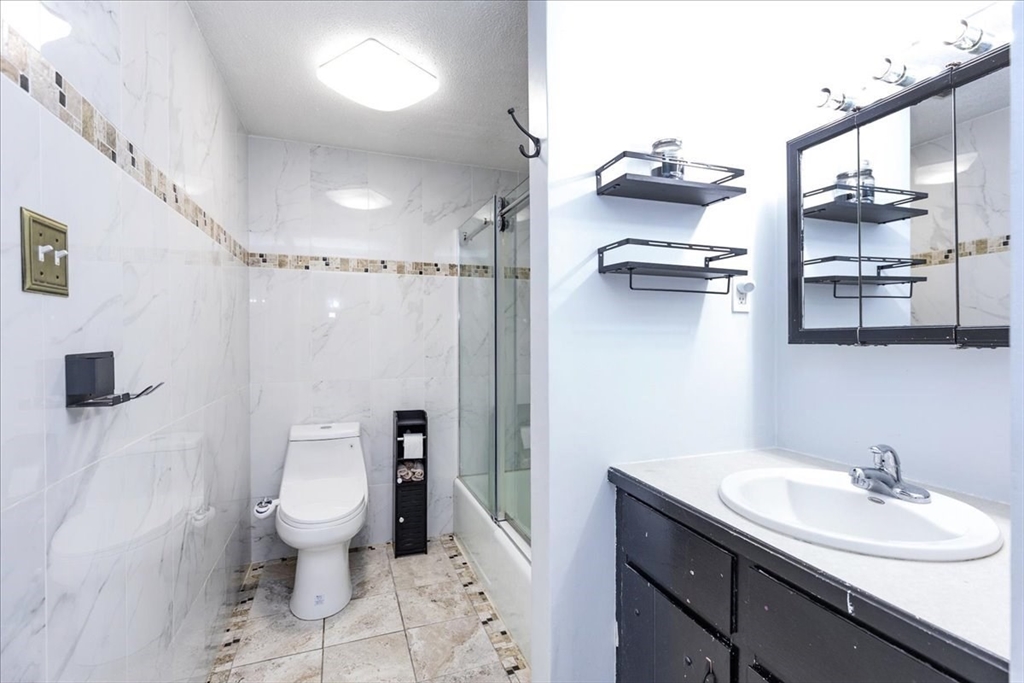 75 Sandy Pond Road, Unit 7 Ayer, MA 01432 - Photo 23 of 37 a bathroom with a sink toilet and shower