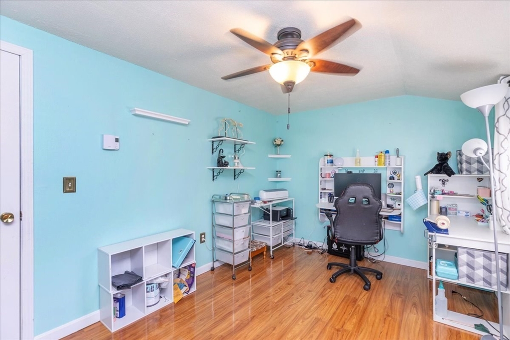 75 Sandy Pond Road, Unit 7 Ayer, MA 01432 - Photo 25 of 37 a view of a workspace with furniture and a ceiling fan