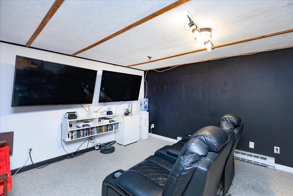 75 Sandy Pond Road, Unit 7 Ayer, MA 01432 - Photo 28 of 37 a living room with furniture and a flat screen tv