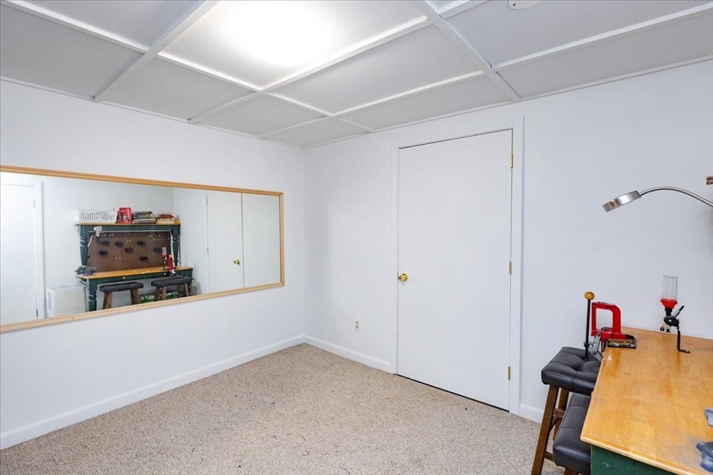 75 Sandy Pond Road, Unit 7 Ayer, MA 01432 - Photo 33 of 37 a room with furniture and a flat screen tv