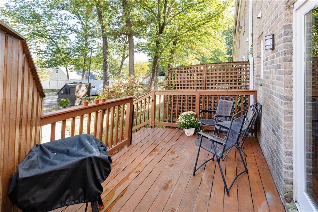 75 Sandy Pond Road, Unit 7 Ayer, MA 01432 - Photo 34 of 37 a view of balcony with wooden floor and outdoor seating