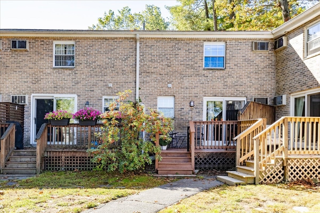 75 Sandy Pond Road, Unit 7 Ayer, MA 01432 - Photo 36 of 37 a view of a house with wooden fence