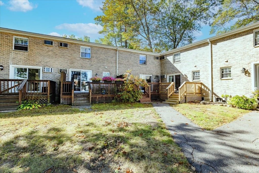 75 Sandy Pond Road, Unit 7 Ayer, MA 01432 - Photo 37 of 37 a backyard of a house with barbeque oven