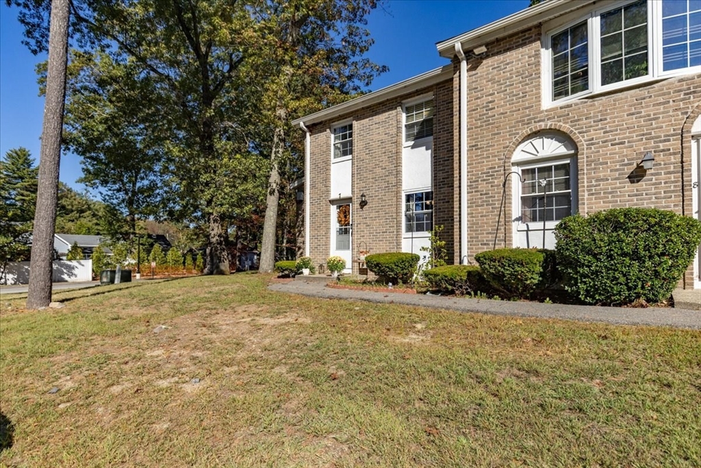 75 Sandy Pond Road, Unit 7 Ayer, MA 01432 - Photo 4 of 37 a front view of a house with garden