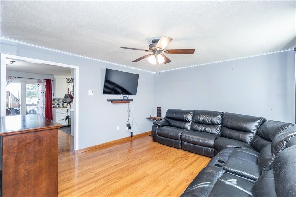 75 Sandy Pond Road, Unit 7 Ayer, MA 01432 - Photo 6 of 37 a living room with furniture and a flat screen tv