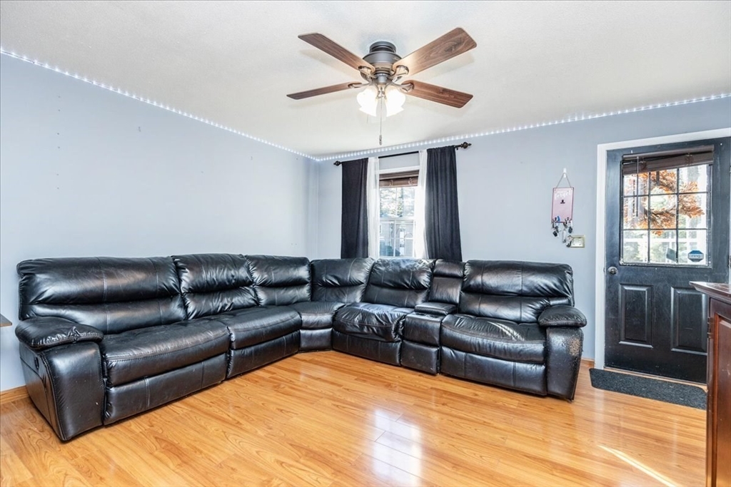 75 Sandy Pond Road, Unit 7 Ayer, MA 01432 - Photo 7 of 37 a living room with furniture and a large window