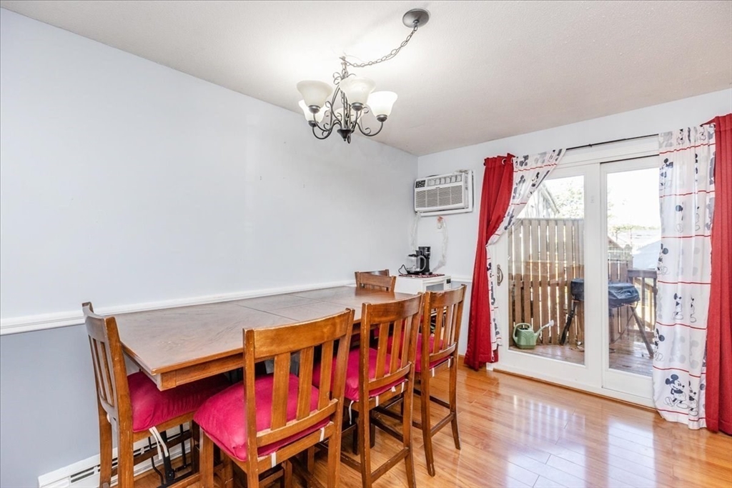75 Sandy Pond Road, Unit 7 Ayer, MA 01432 - Photo 10 of 37 a view of a dining room with furniture and wooden floor