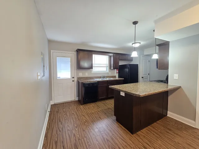 a kitchen with a sink a counter top space and stainless steel appliances
