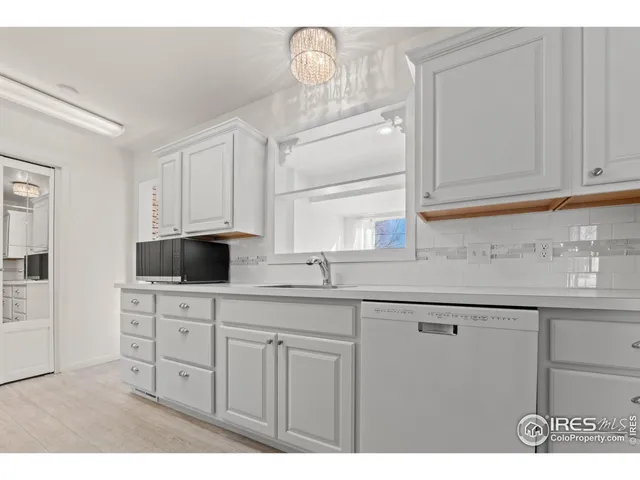 a kitchen with cabinets appliances and a sink