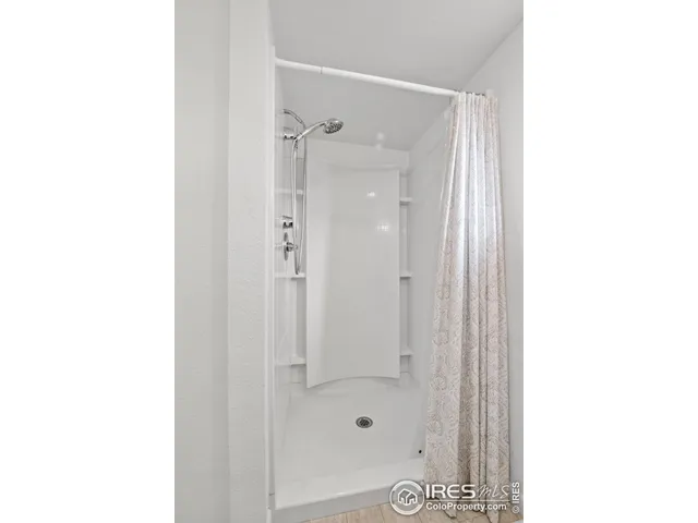 a bathroom with a glass shower door