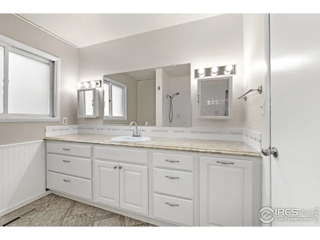 a bathroom with a granite countertop sink a mirror and a