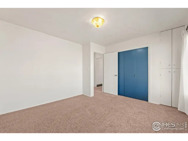 a view of an empty room and a fan
