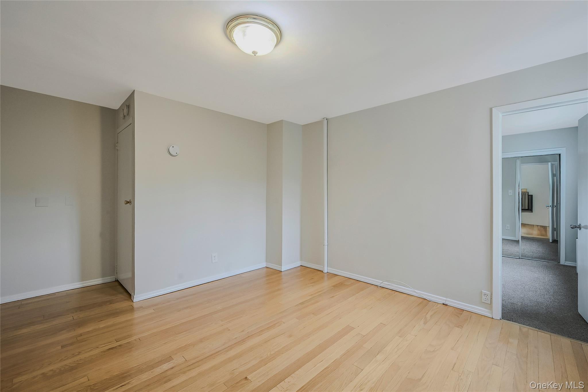 148 South 4th Street Bethpage, NY 11714 - Photo 5 of 16 a view of empty room with wooden floor