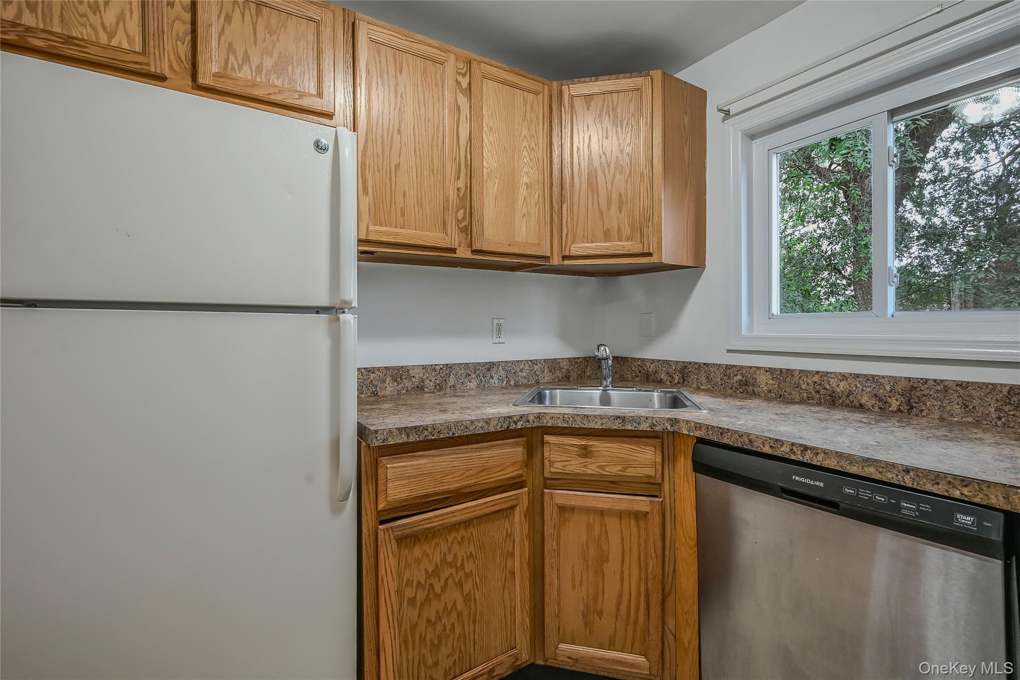 148 South 4th Street Bethpage, NY 11714 - Photo 6 of 16 a kitchen with stainless steel appliances granite countertop a sink and a refrigerator