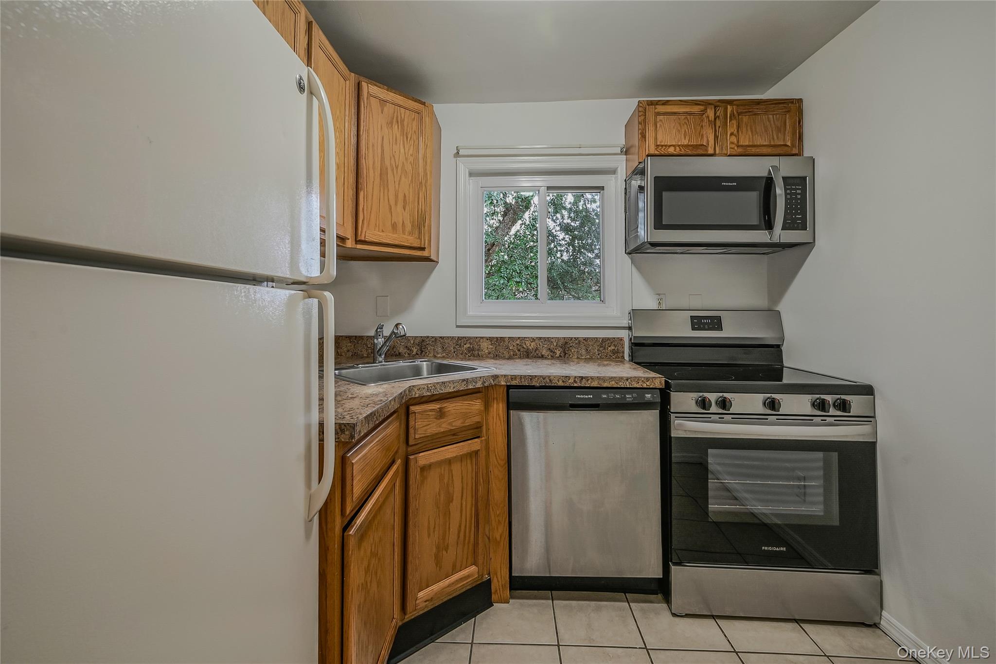 148 South 4th Street Bethpage, NY 11714 - Photo 7 of 16 a kitchen with a stove and a microwave