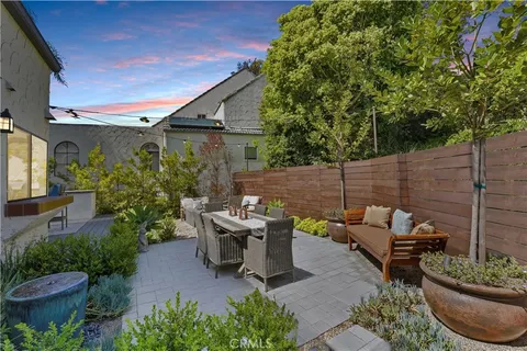 a view of a patio with table and chairs potted plants with wooden floor