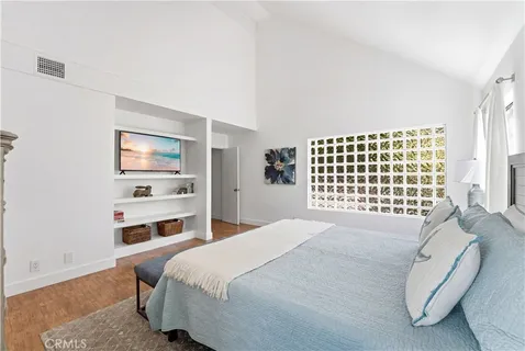 a bedroom with a bed and a window