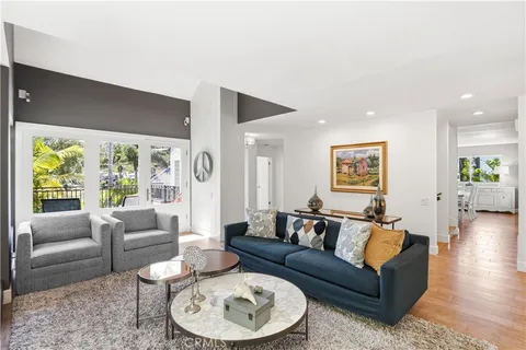a living room with furniture a fireplace and a large window
